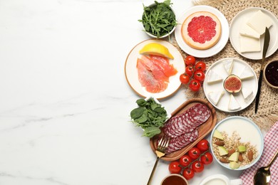 Photo of Different tasty food served for brunch on white marble table, flat lay. Space for text