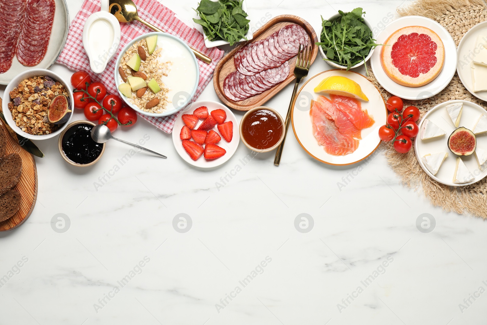 Photo of Different tasty food served for brunch on white marble table, flat lay. Space for text