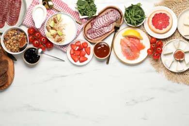 Photo of Different tasty food served for brunch on white marble table, flat lay. Space for text