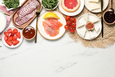 Photo of Different tasty food served for brunch on white marble table, flat lay. Space for text