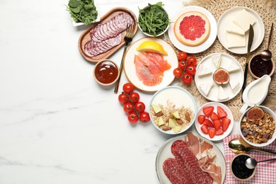 Photo of Different tasty food served for brunch on white marble table, flat lay. Space for text