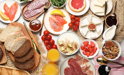 Photo of Different tasty food served for brunch on white table, flat lay