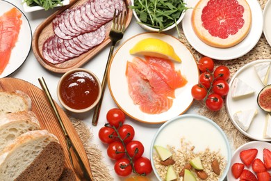 Photo of Different tasty food served for brunch on white table, flat lay