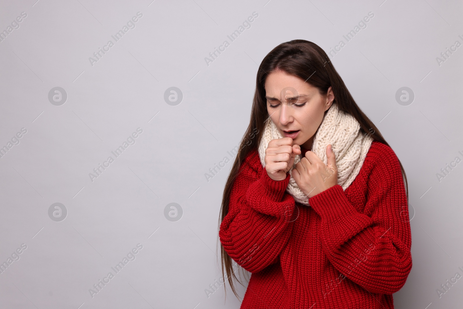 Photo of Sick woman coughing on grey background, space for text. Cold symptoms