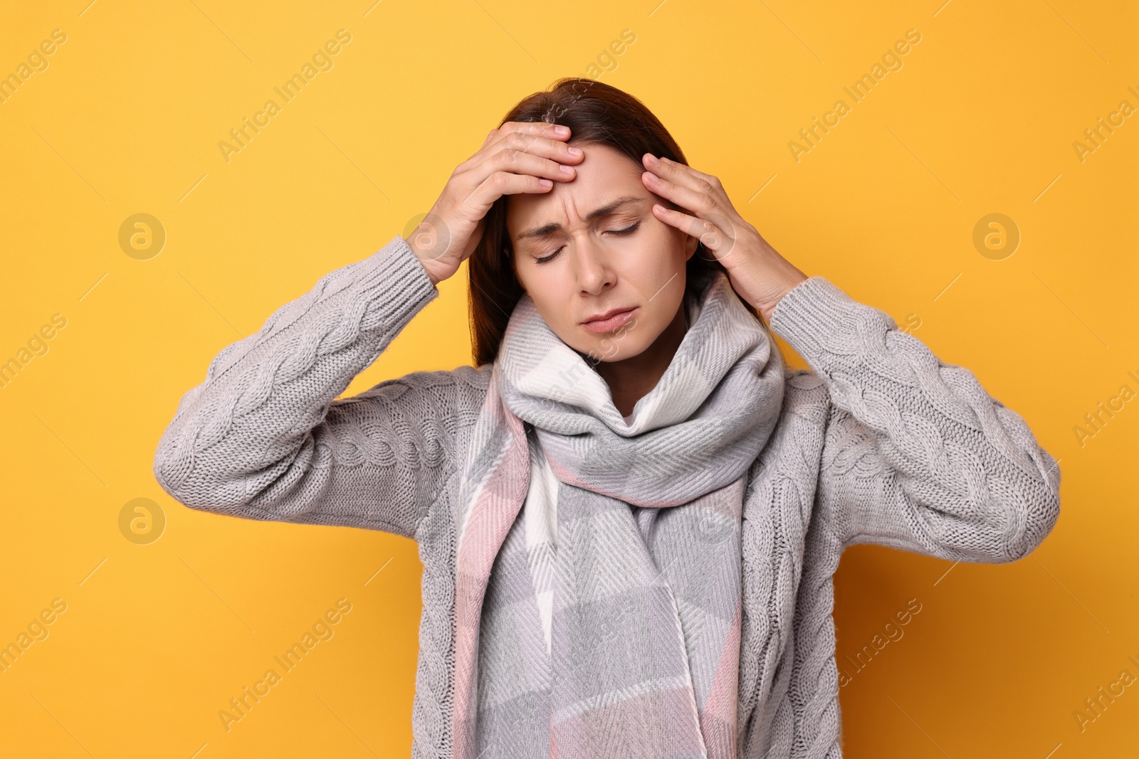 Photo of Sick woman suffering from cold symptoms on orange background