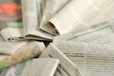 Photo of Many newspapers in different languages as background, closeup