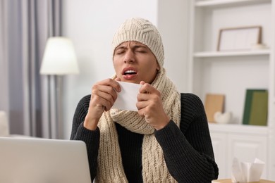 Cold symptom. Young man coughing at home