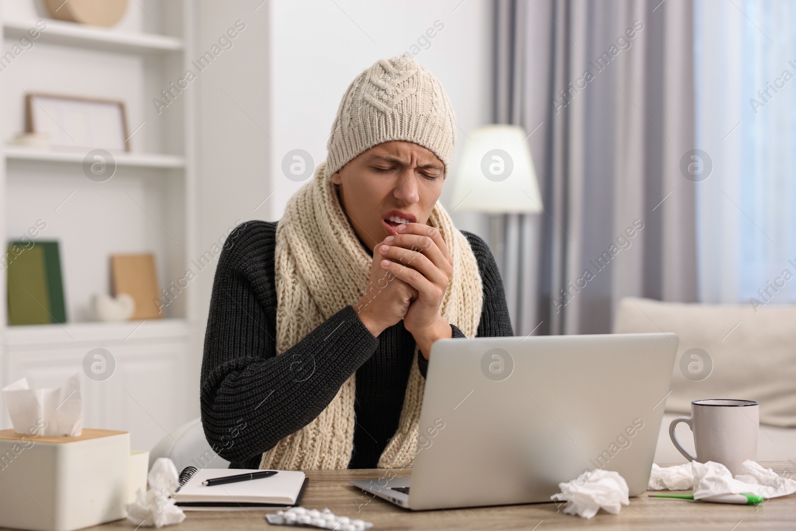 Photo of Cold symptom. Young man suffering from fever at desk indoors