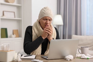 Photo of Cold symptom. Young man suffering from fever at desk indoors