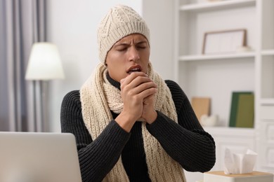 Cold symptom. Young man coughing at home