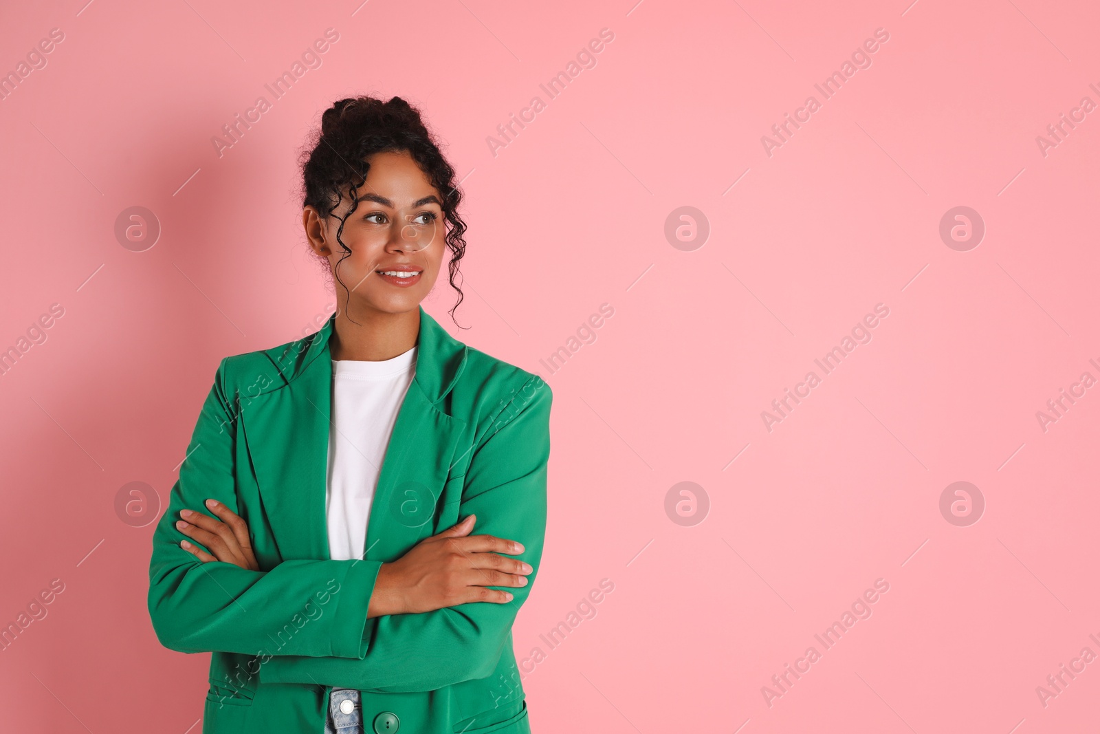 Photo of Beautiful woman in stylish jacket on pink background, space for text