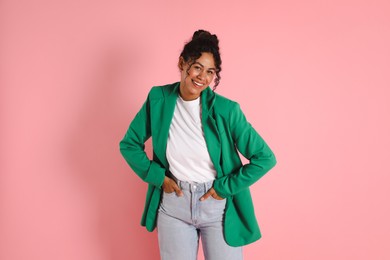 Photo of Beautiful woman in stylish jacket on pink background