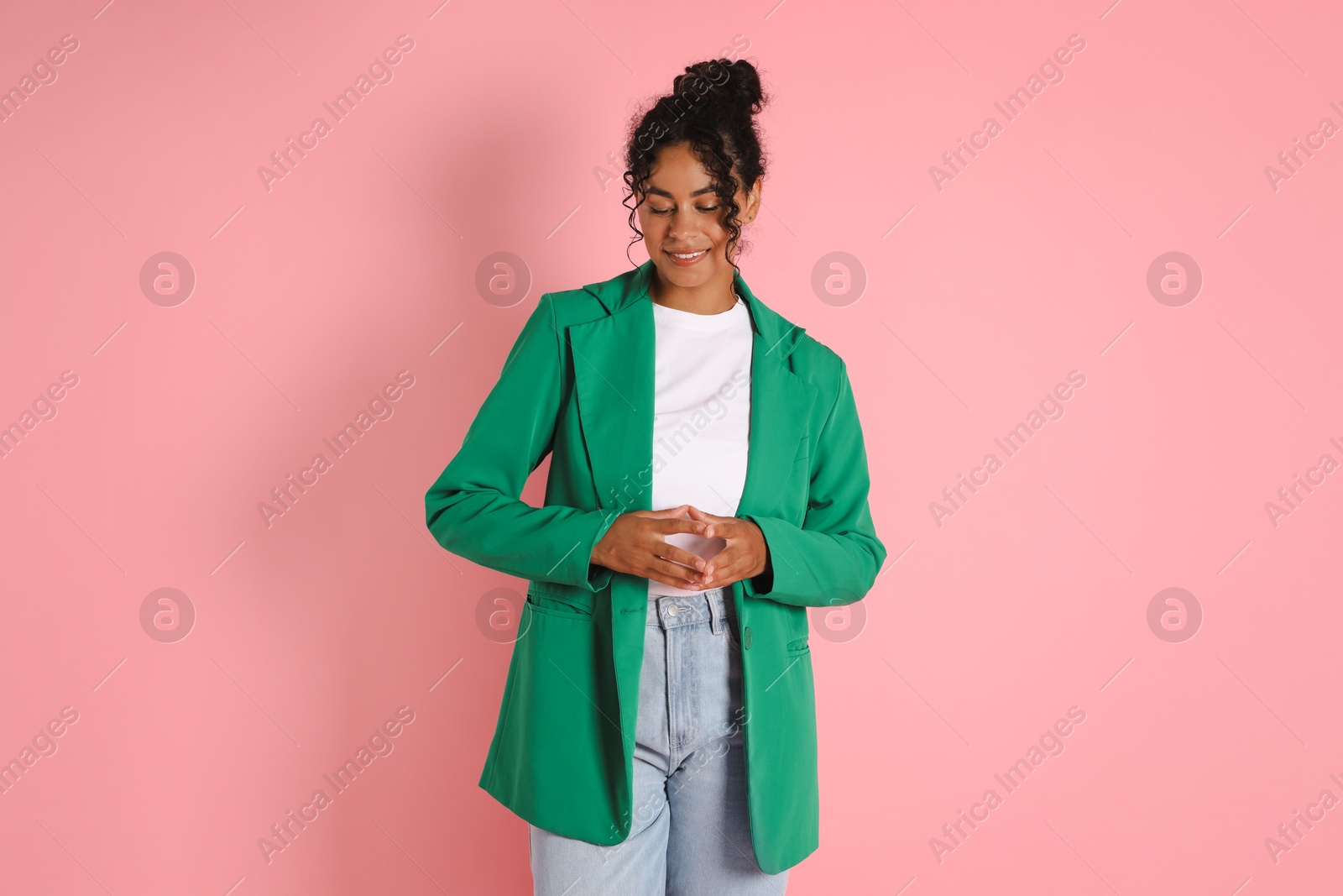 Photo of Beautiful woman in stylish jacket on pink background