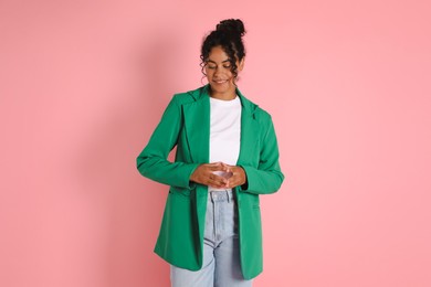 Photo of Beautiful woman in stylish jacket on pink background