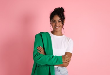 Beautiful woman with stylish jacket on pink background