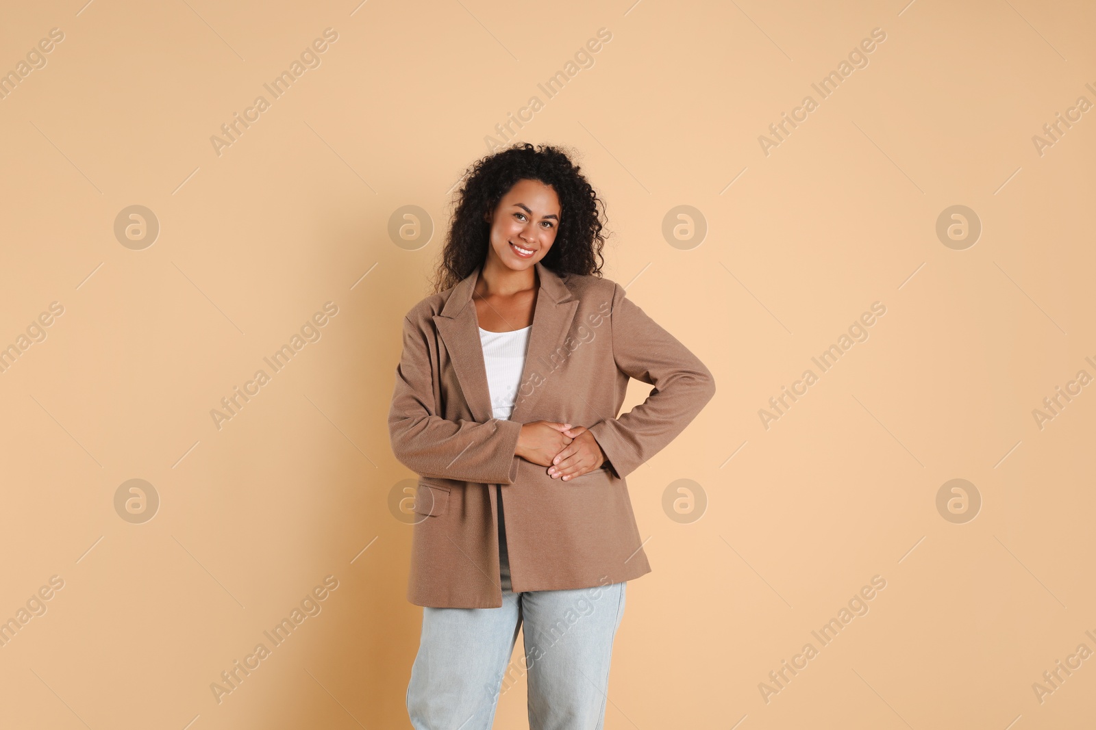 Photo of Beautiful woman in stylish jacket on beige background