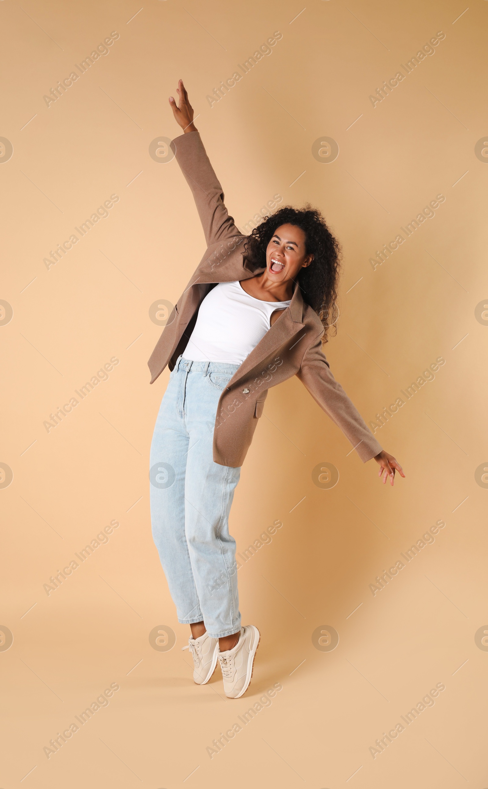 Photo of Beautiful woman in stylish jacket on beige background