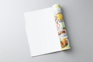 Photo of Open magazine on grey background, top view. Mockup for design