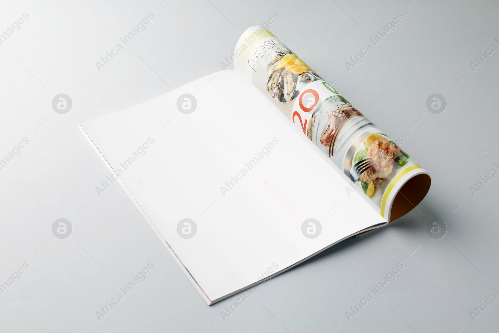 Photo of Open magazine on grey background. Mockup for design