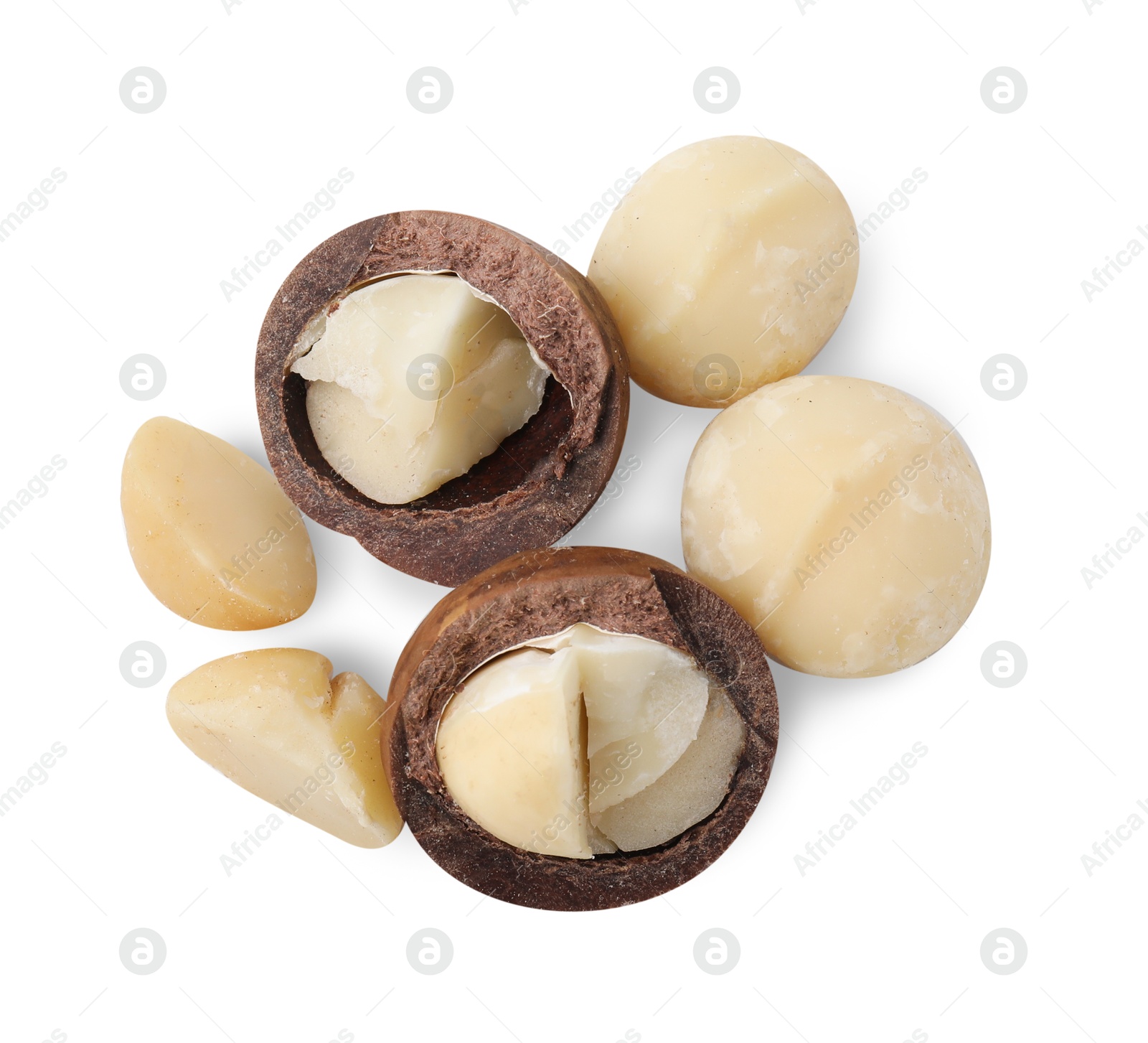 Photo of Macadamia nuts with shells isolated on white, top view