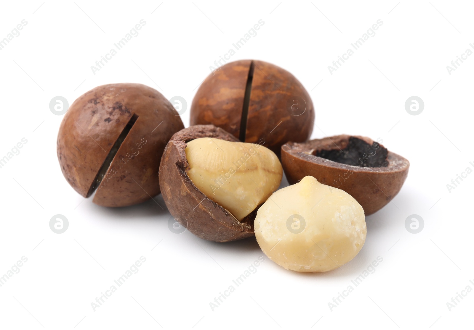 Photo of Macadamia nuts with shells isolated on white