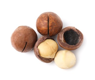 Photo of Macadamia nuts with shells isolated on white, top view