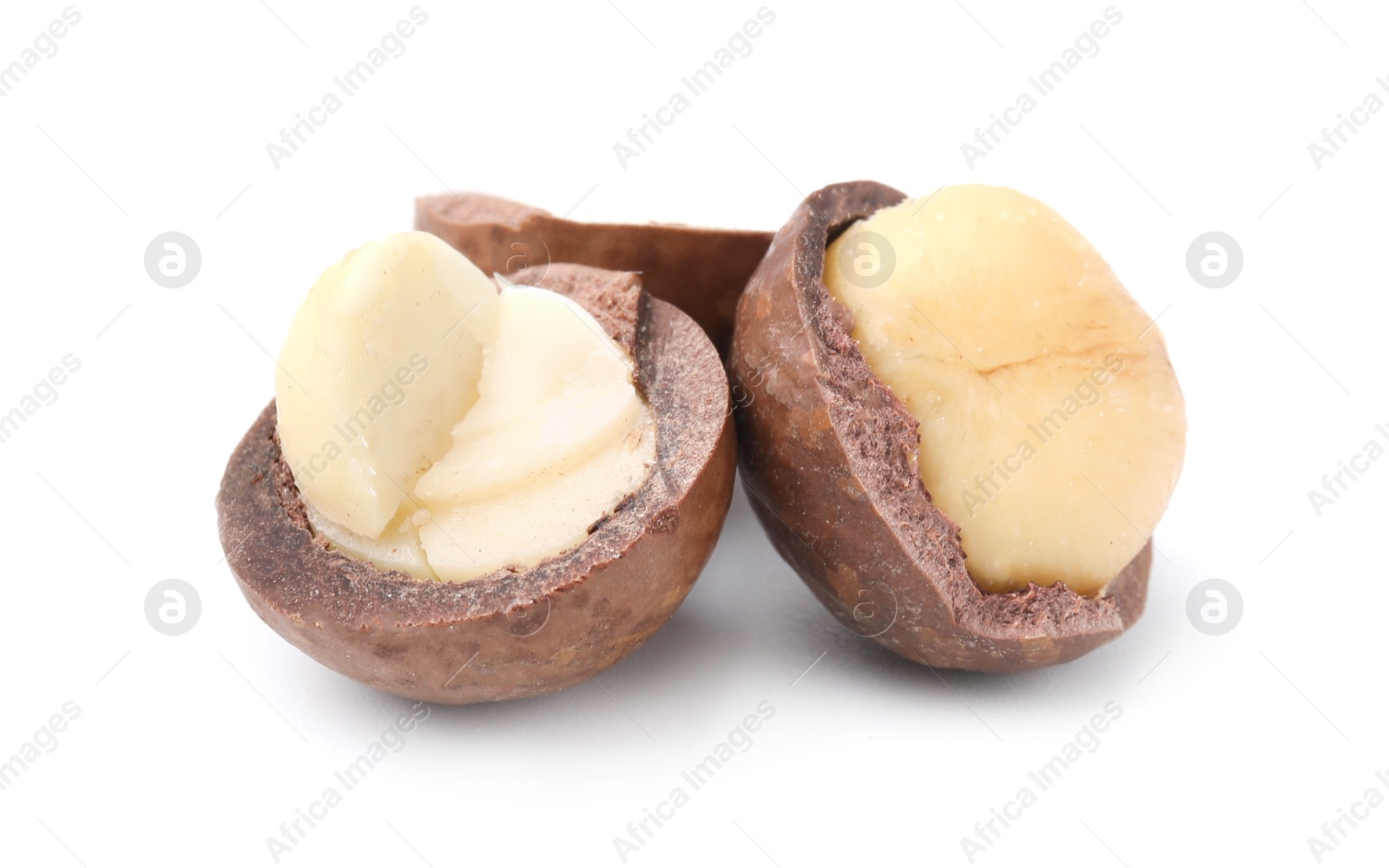 Photo of Macadamia nuts with shells isolated on white