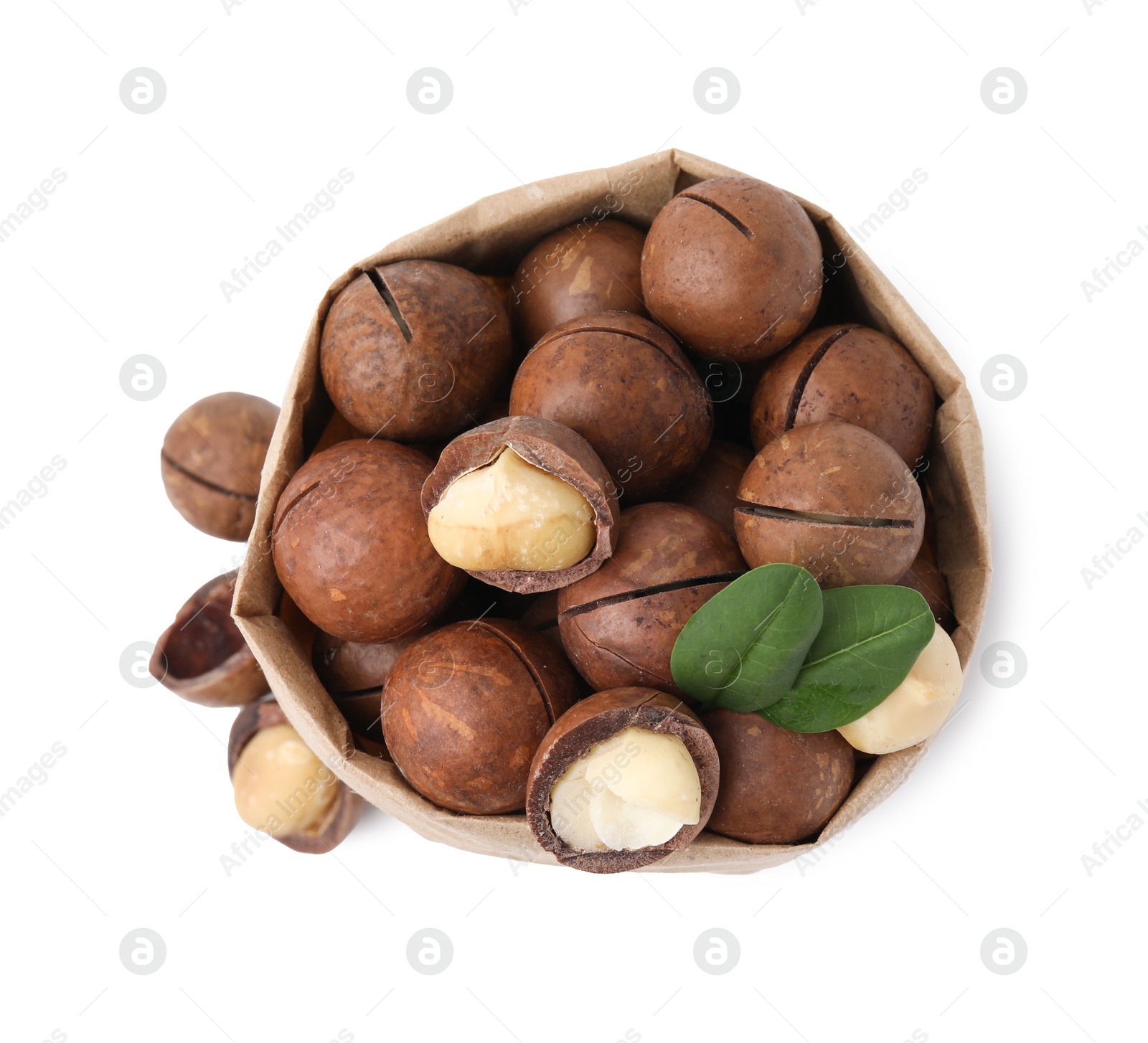 Photo of Macadamia nuts in paper bag isolated on white, top view