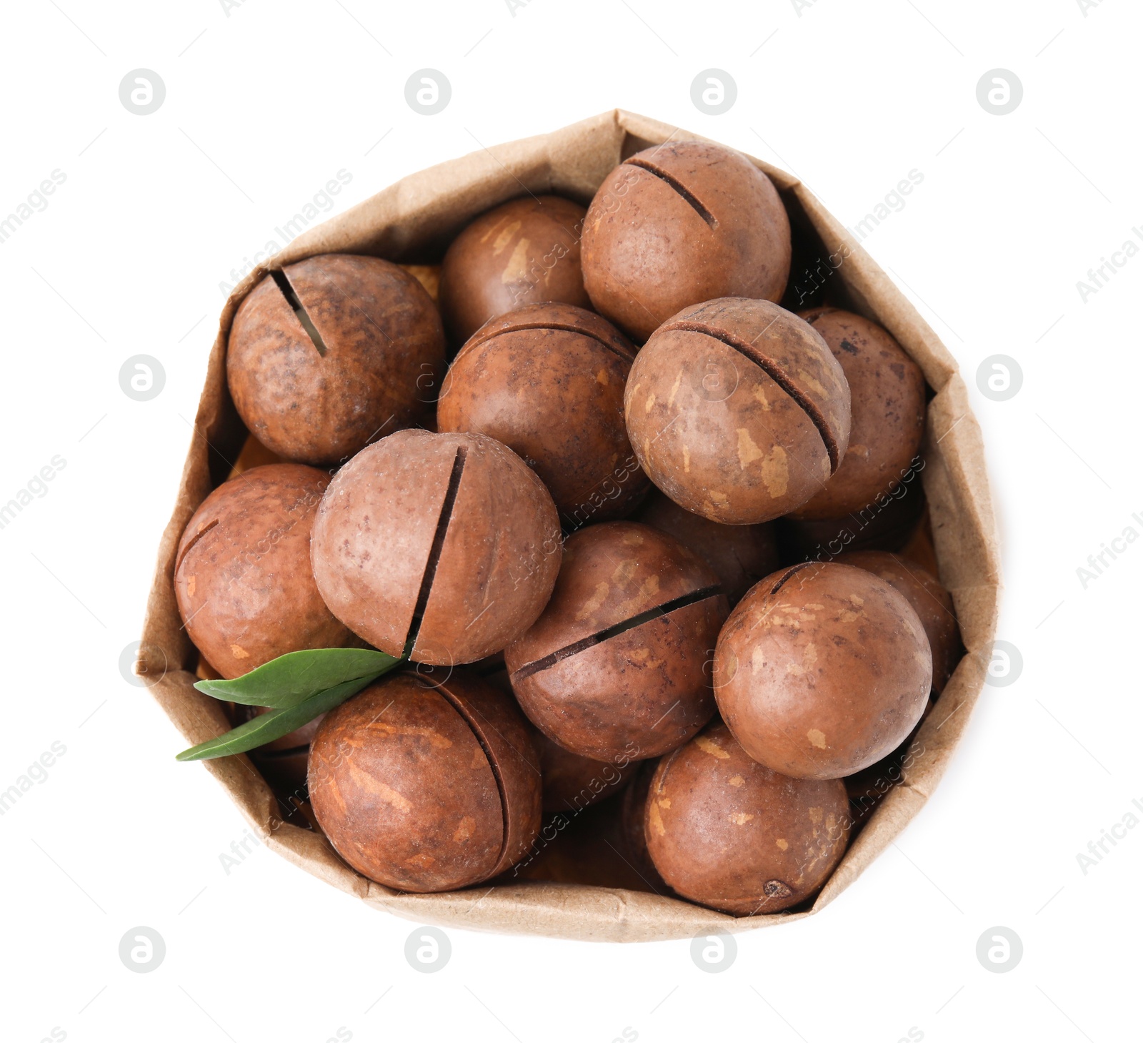 Photo of Macadamia nuts in paper bag isolated on white, top view