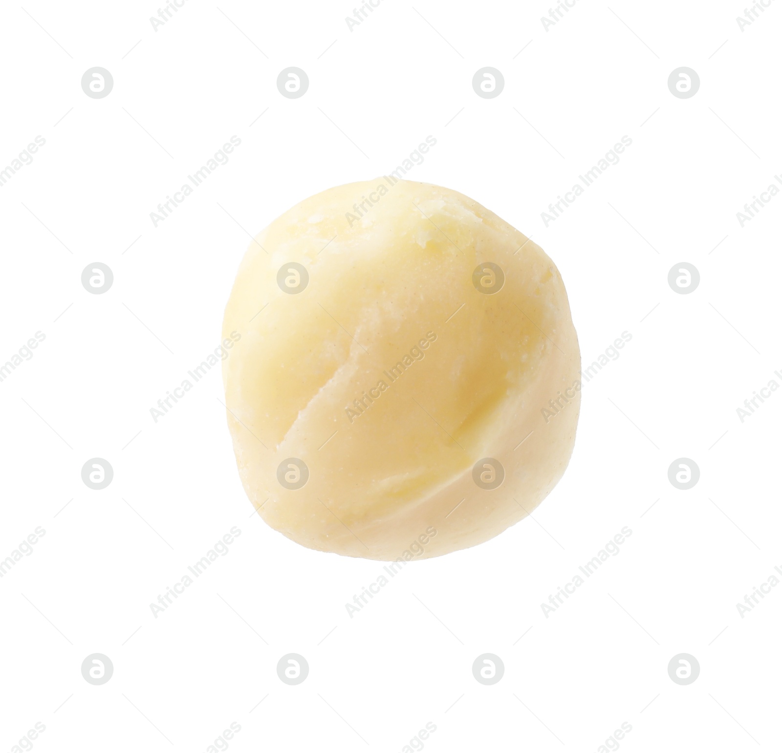 Photo of One peeled macadamia nut isolated on white