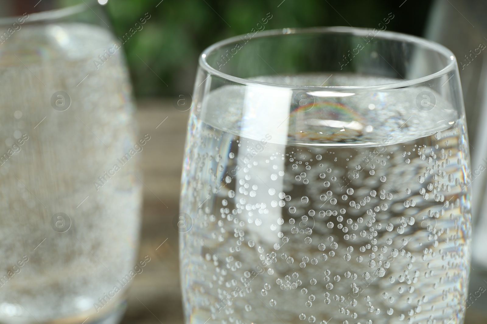 Photo of Soda water in glasses on table, closeup