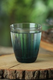 Photo of Soda water in glass on wooden table outdoors