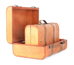 Photo of Three new wooden suitcases isolated on white