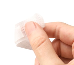 Photo of Woman putting medical adhesive bandage on white background, closeup