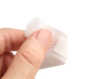 Photo of Woman putting medical adhesive bandage on white background, closeup