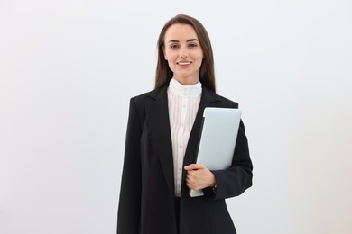 Portrait of smiling businesswoman with laptop on white background