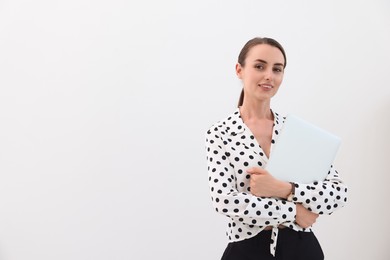 Portrait of smiling businesswoman with laptop on white background. Space for text