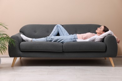 Beautiful woman relaxing on sofa at home