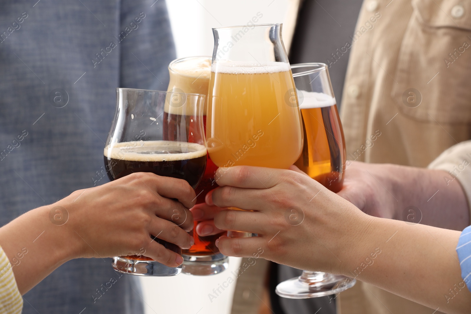 Photo of People with different types of beer clinking glasses, closeup