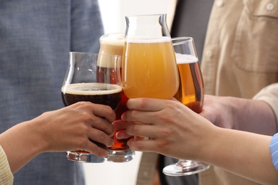 Photo of People with different types of beer clinking glasses, closeup