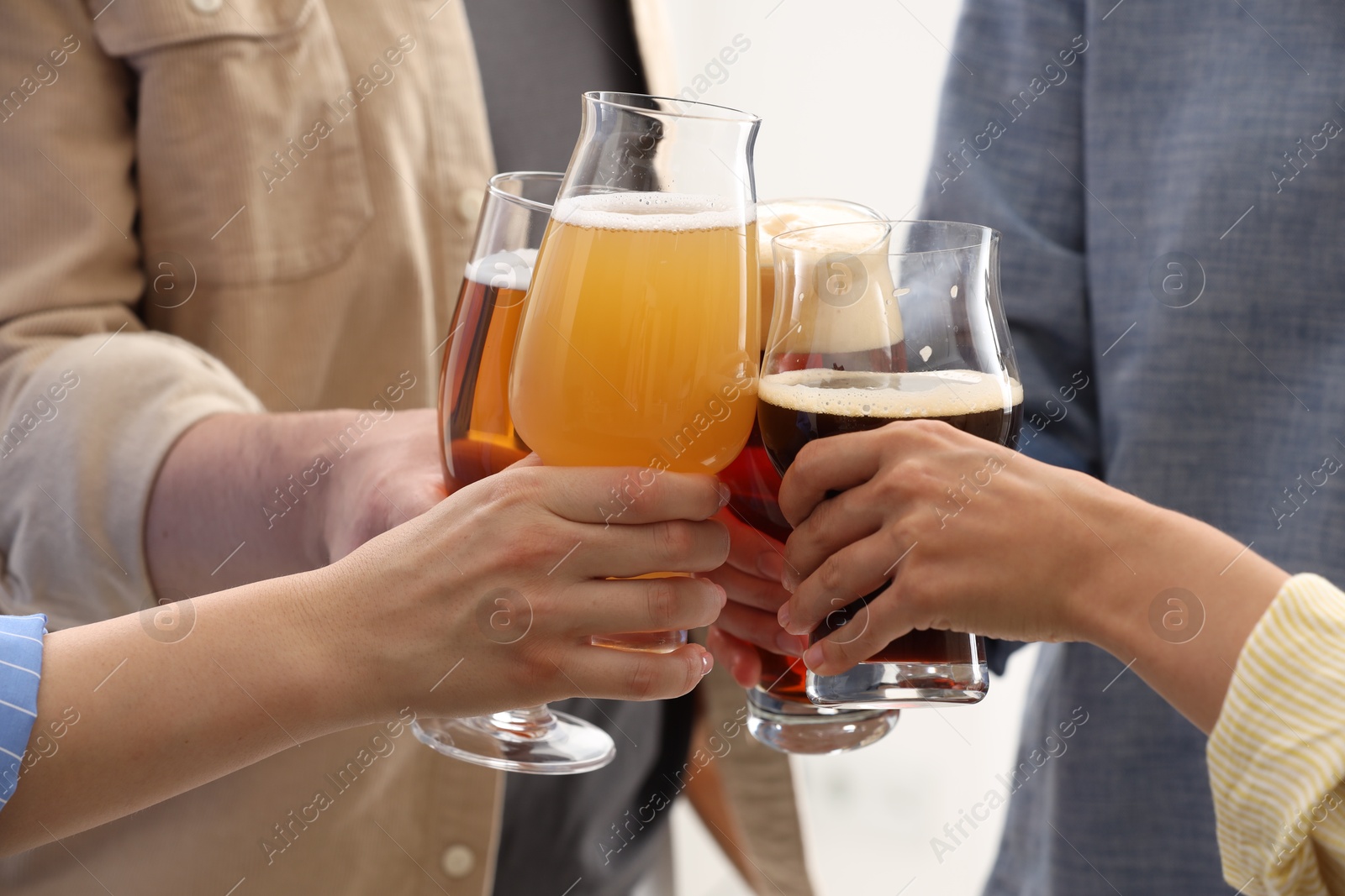 Photo of People with different types of beer clinking glasses, closeup