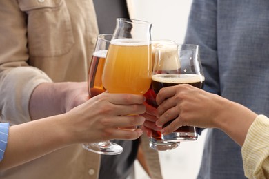 Photo of People with different types of beer clinking glasses, closeup