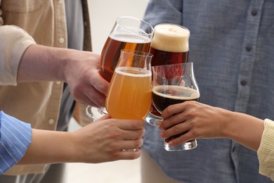 Photo of People with different types of beer clinking glasses, closeup