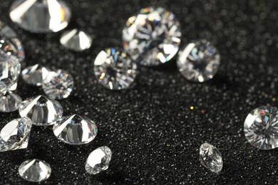 Beautiful dazzling diamonds on dark shiny background, closeup