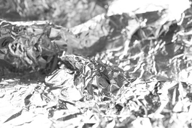 Photo of Shiny silver tinfoil surface as background, closeup