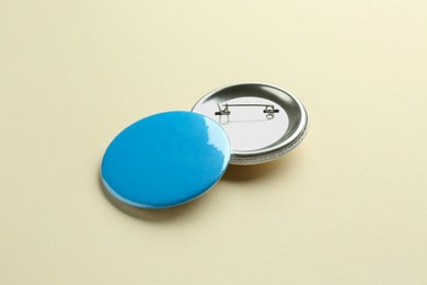 Photo of Button badges on beige background. Mockup for design