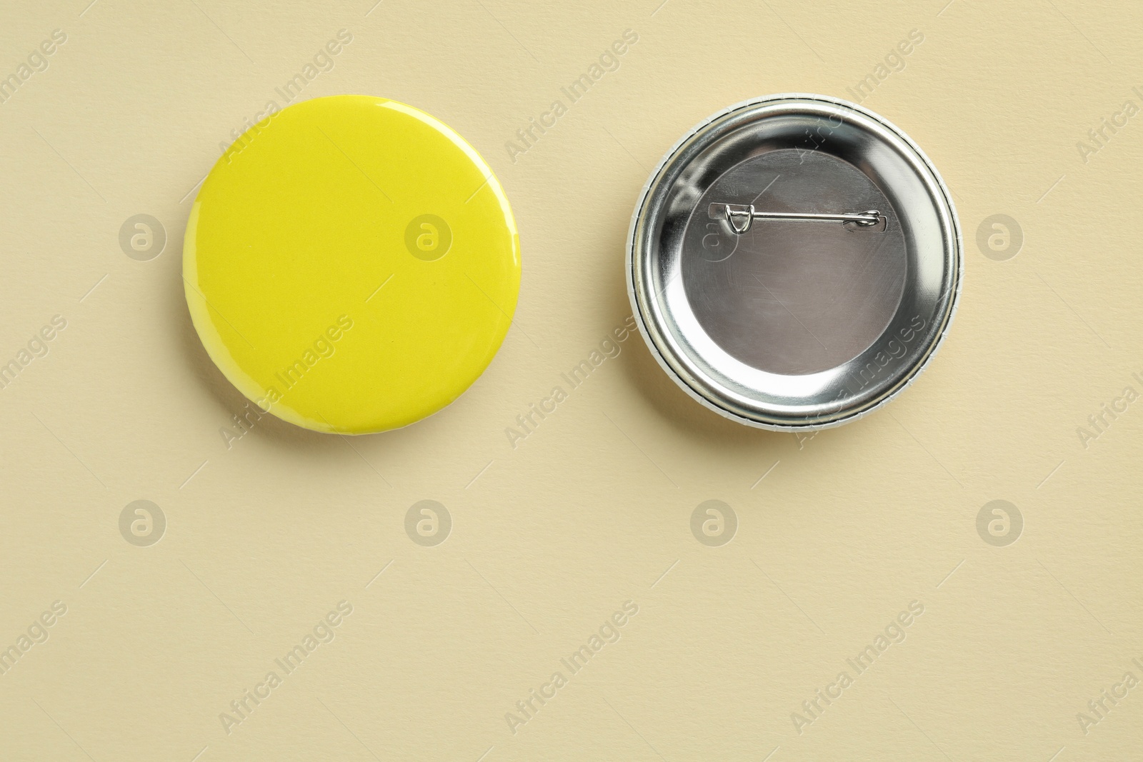 Photo of Button badges on beige background, flat lay. Mockup for design