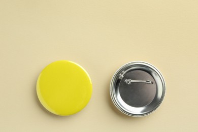 Photo of Button badges on beige background, flat lay. Mockup for design