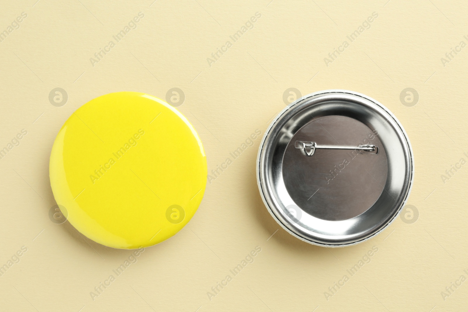 Photo of Button badges on beige background, flat lay. Mockup for design