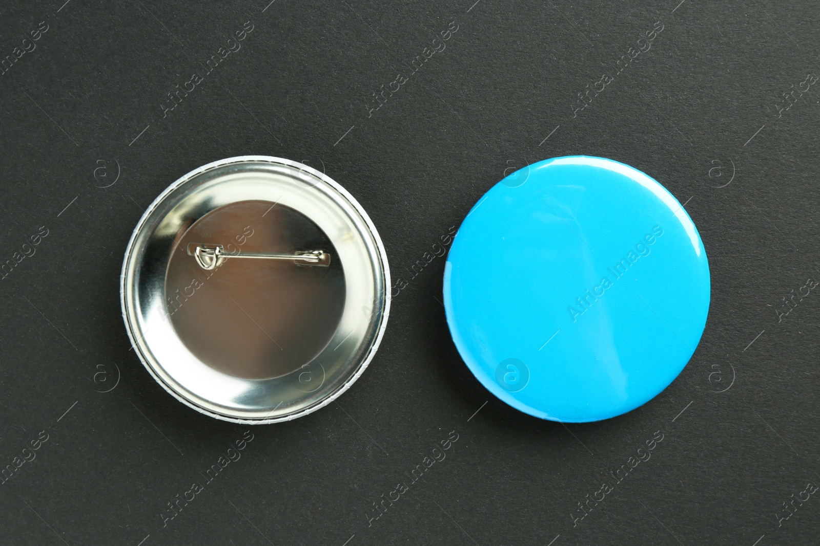 Photo of Button badges on black background, flat lay. Mockup for design